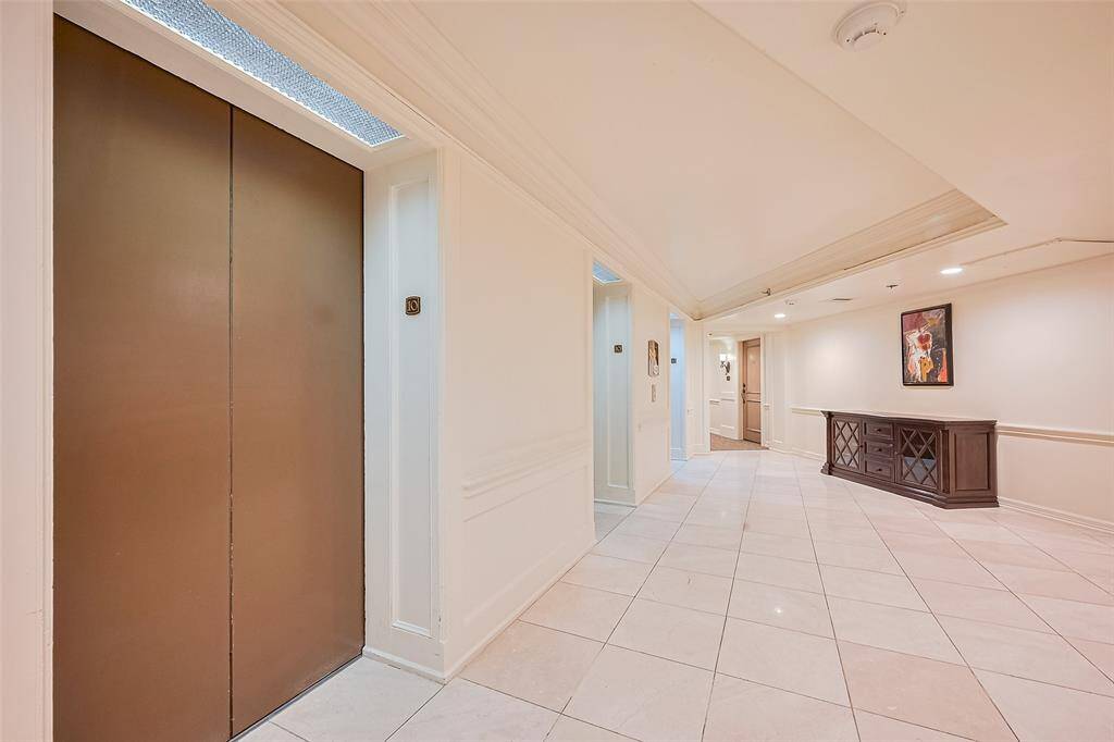 A polished elevator lobby welcomes residents and guests with gleaming tile floors and understated sophistication.