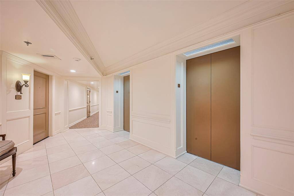 Another perspective reveals the smooth transition from the elevator lobby into the carpeted residential hallway.