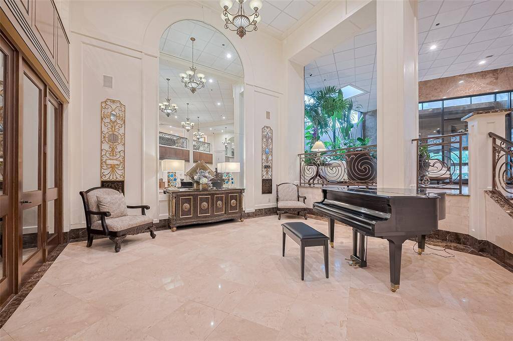 Soaring ceilings and marble floors define this impressive lobby, where contemporary comfort meets timeless elegance.