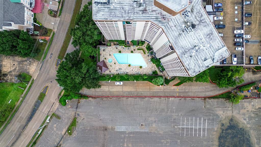 This aerial shot captures the building’s profile and central pool area, showcasing the thoughtful layout from above.