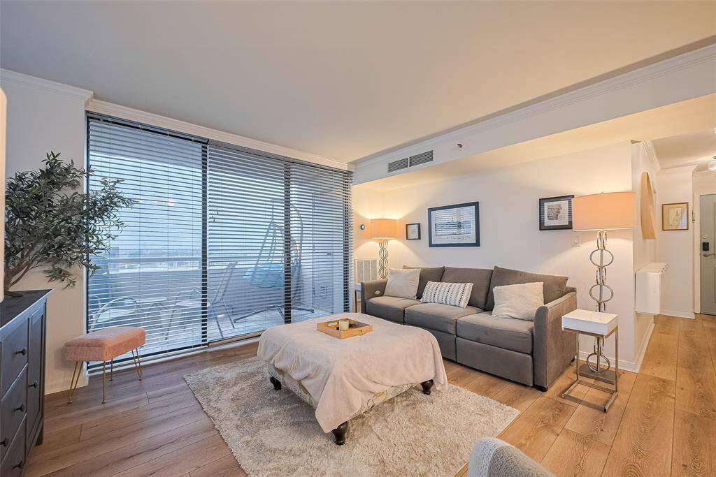Another angle of the living area highlights its seamless connection to the balcony, blurring the lines between indoor comfort and the sweeping views beyond.