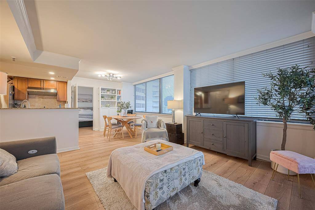 The living area flows effortlessly into the kitchen and dining space, creating an interconnected environment perfect for hosting or everyday ease.