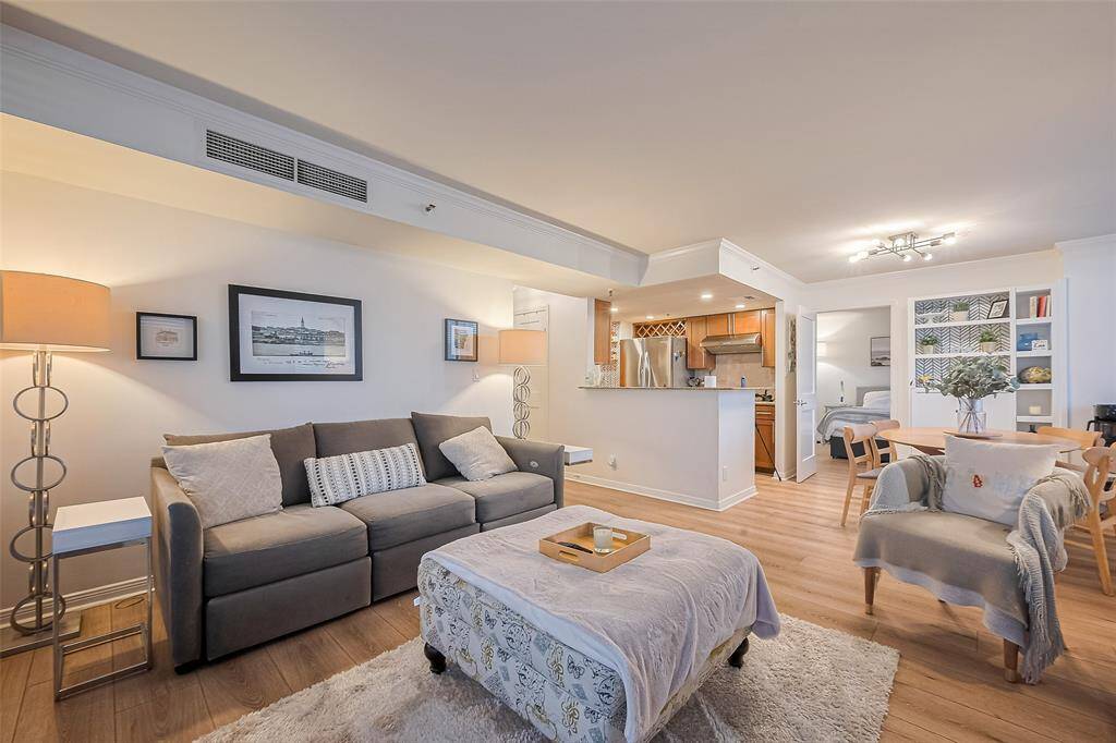 This angle shows the living room’s connection to the kitchen and dining area, with the primary bedroom tucked discreetly to the right.
