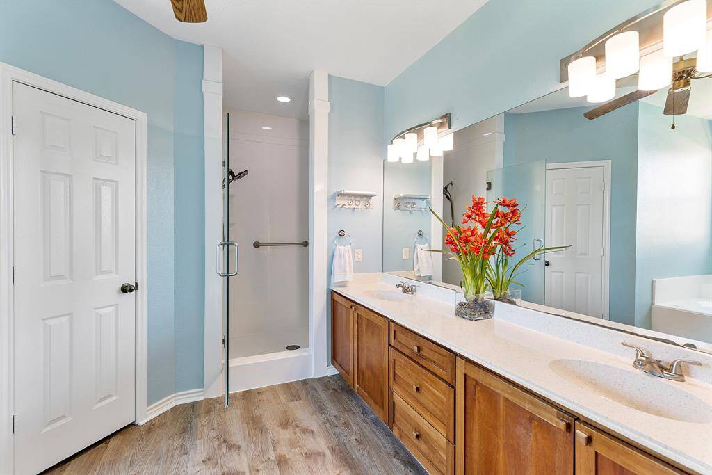 Spacious primary bedroom at the rear, overlooking the pool and patio.