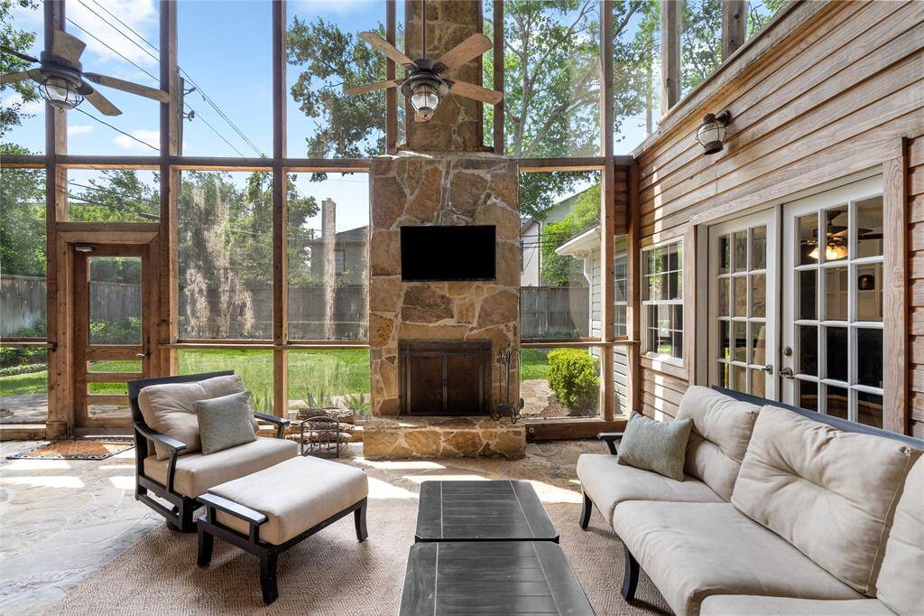 WOW this outdoor screened in patio with wood buring fireplace is a dream.