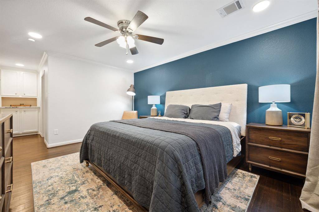Rest easy in this dreamy primary suite—complete with bold accent wall, soft lighting....
