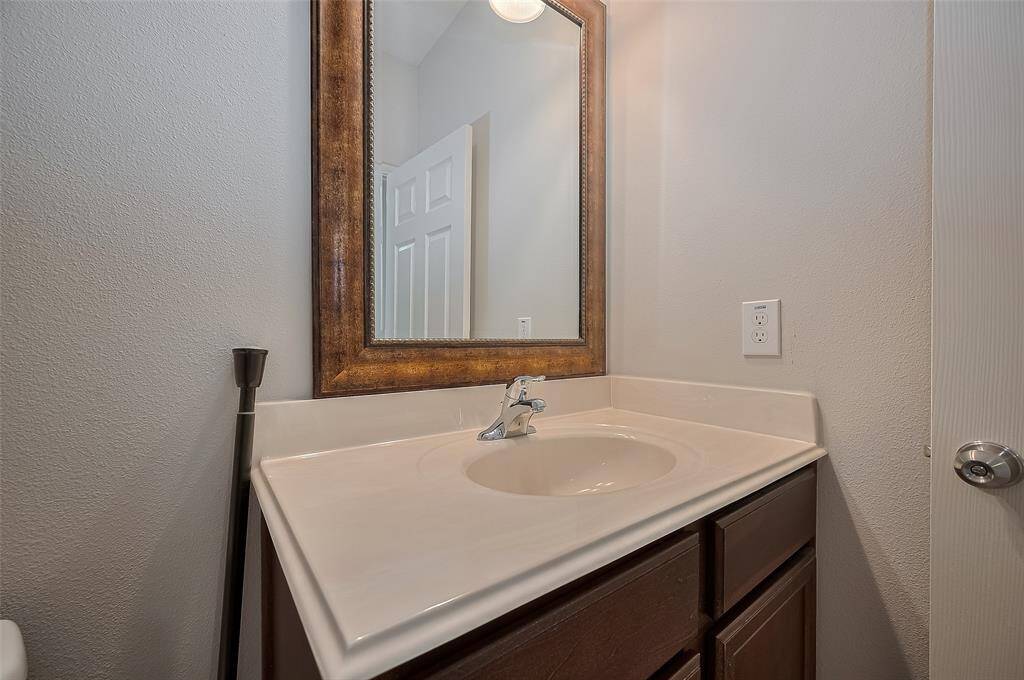 Secondary bathroom sink and mirror.