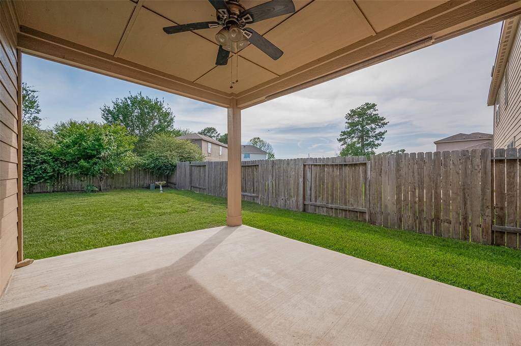 Covered patio with a fan outside.