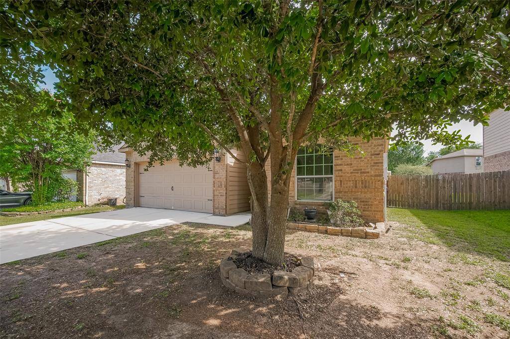 Another view of the home and with a mature tree.