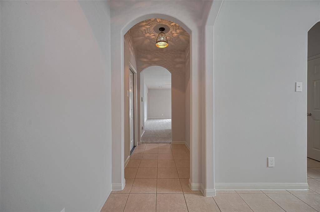 The hallway leading to the living area and Kitchen.