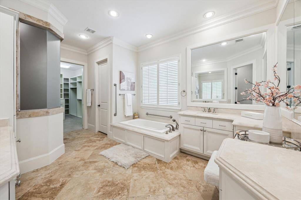 This spa-like ensuite bath features dual sinks plus a vanity jetted tub and separate shower.