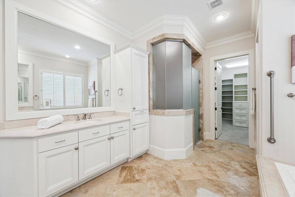 With generous storage and expansive mirrors, the bathroom makes your morning routine effortless.