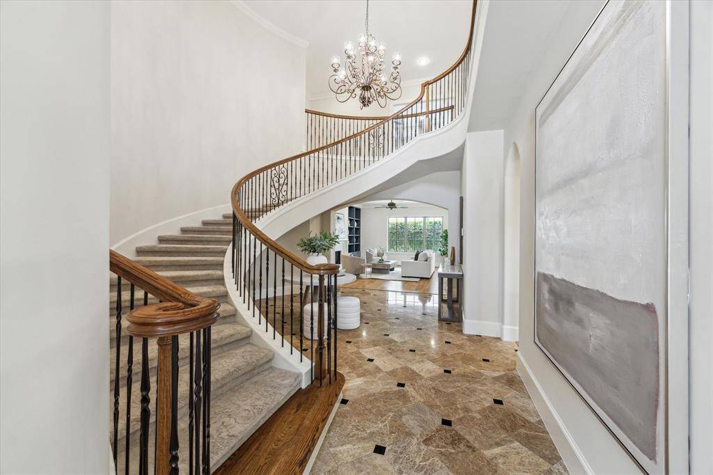 Upon entry, you're welcomed by a grand staircase and soaring ceilings that create a bright, open feel.