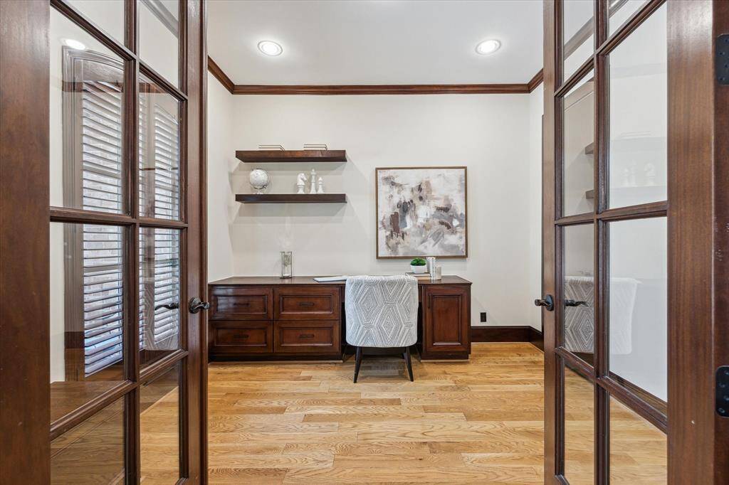 The home office features a built-in desk, hardwood floors and a closet.