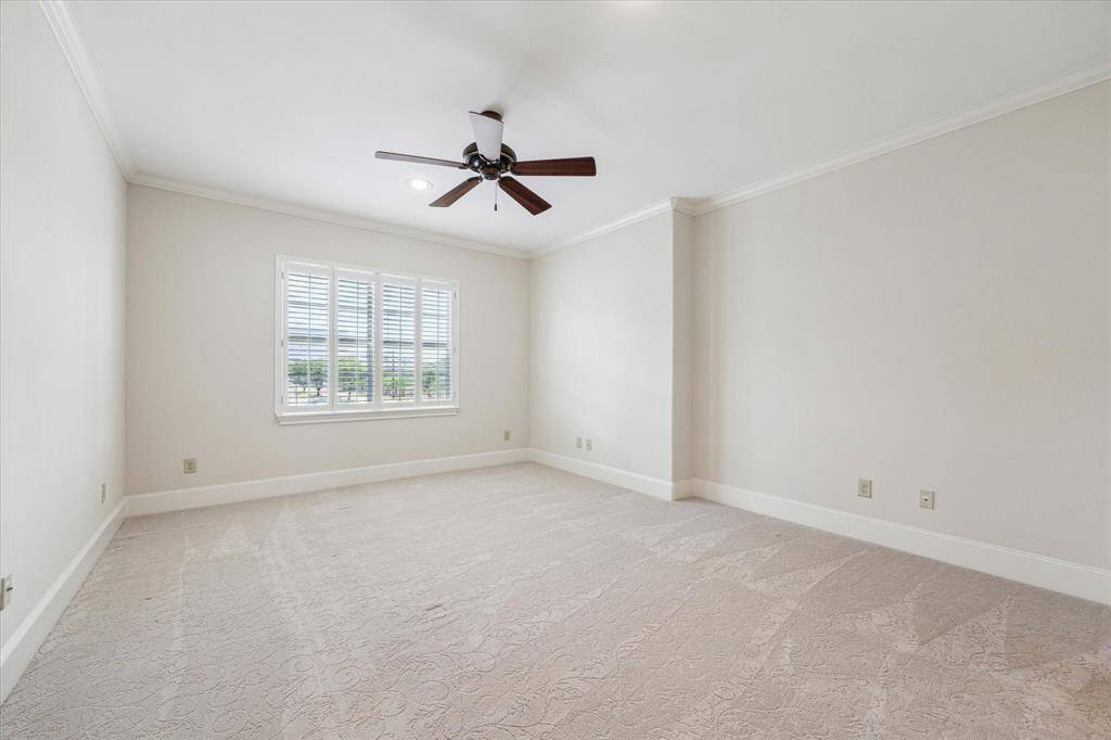 Third bedroom with an ensuite bath, walk-in closet, ceiling fan, plantation shutters and recessed lighting.