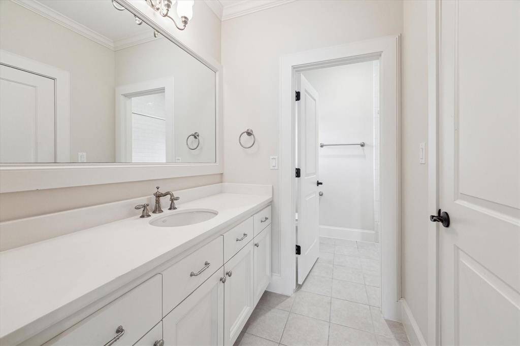 Ensuite bath for secondary bedroom with a shower/ tub combo, ample counter space and storage.