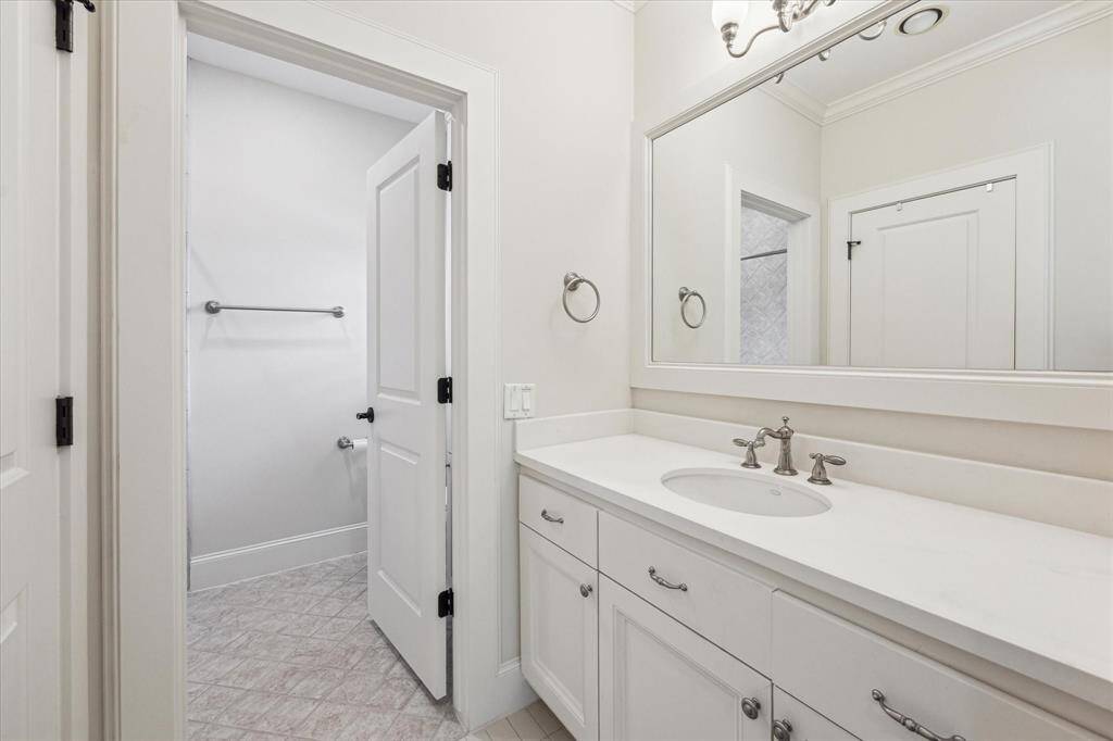 Ensuite bath for secondary bedroom with a shower/ tub combo, ample counter space and storage.