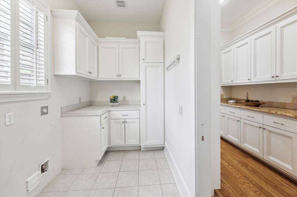 Spacious laundry room with plenty of storage as well as a second refrigerator (not pictured).