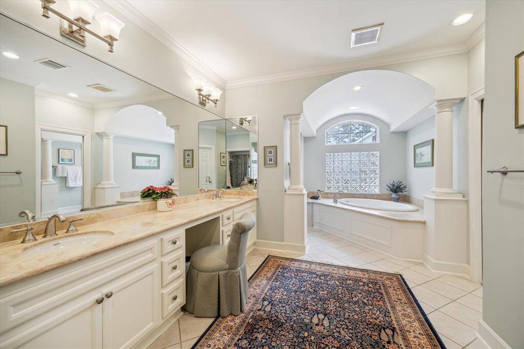 The primary bathroom is as a Texas bathroom should be: double sinks, a dressing area, soaking tub and private shower and commode areas.  The glass blocks provide nice lighting to the room.