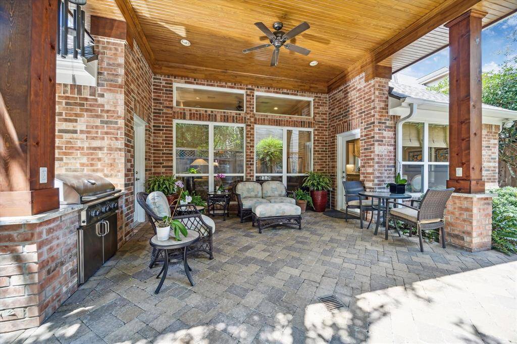 Party on the patio!  The covered back porch and patio with its high beaded wood ceiling and barbecue grill is a great place for entertaining.