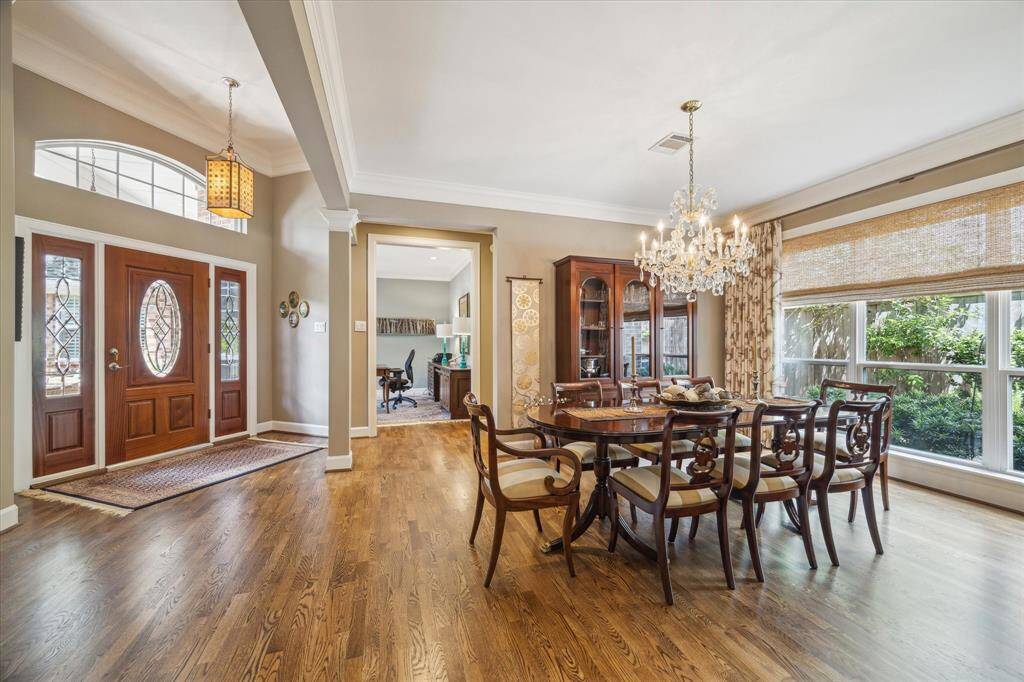 The spacious dining room just past the entry has a view of the landscaped side yard.  The office/study is through the  door to the right of the entry.  Beautiful shades enahnce the windows throughout the home.