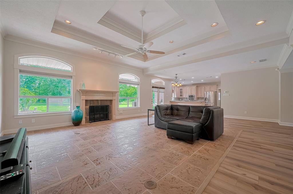 Altho this room is currently sporting one small sofa, it is built to accomodate all of your family room furniture.  In the very back of the photo is the kitchen.