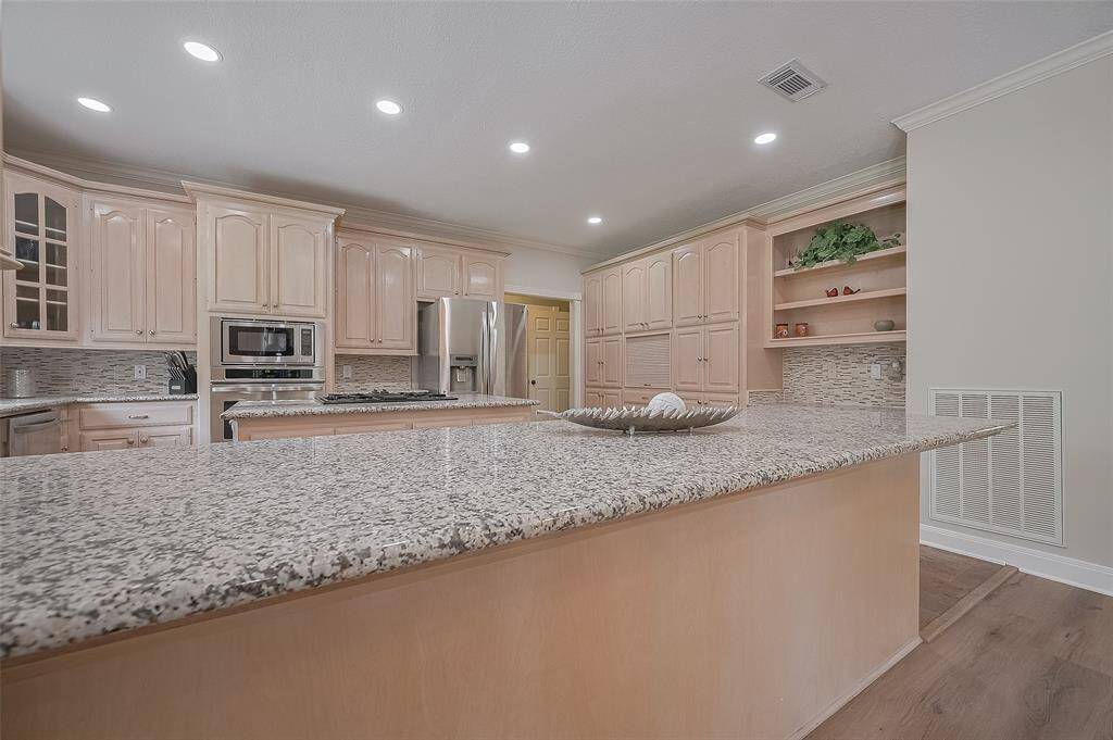 Gorgeous Granite countertops are the focal point of this kitchen and offer ample space for dinner prep work or just pulling up a stool and hanging out at the breakfast bar.