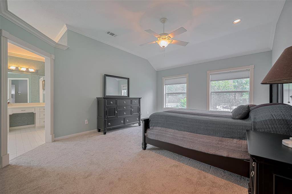 The serene primary bedroom offers brand-new carpet, recessed lighting, and peaceful views of the private backyard—your perfect retreat at the end of the day.