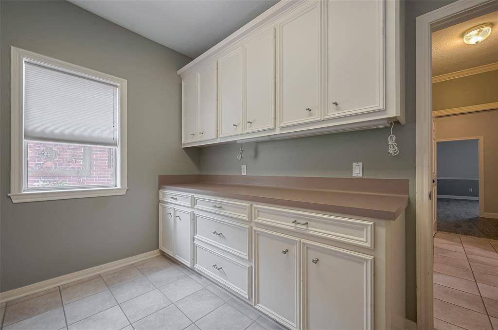 and on this side of the laundry room is a folding area plus even more storage space!!