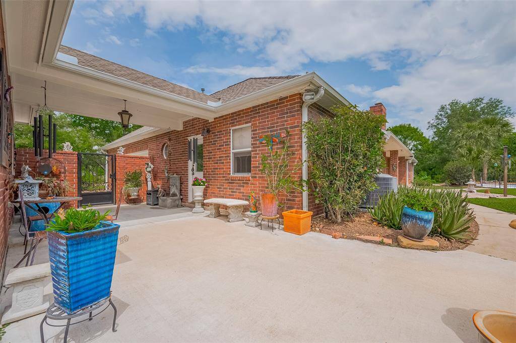This charming and relaxing porte cochere entry leads you gracefully to the backyard oasis. This stunning exterior sets the tone for a home filled with warmth, personality, and thoughtful design.