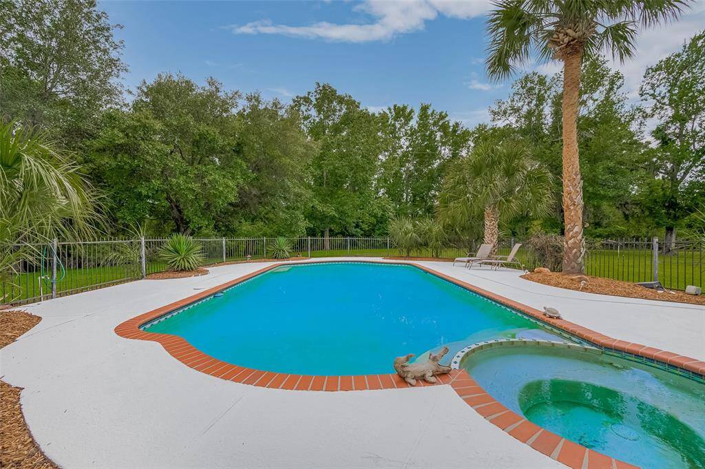Private Oasis with Sparkling Pool! Escape to your own secluded paradise! This stunning home features a gated  resort-style pool and relaxing spa — all tucked away on a huge private lot.