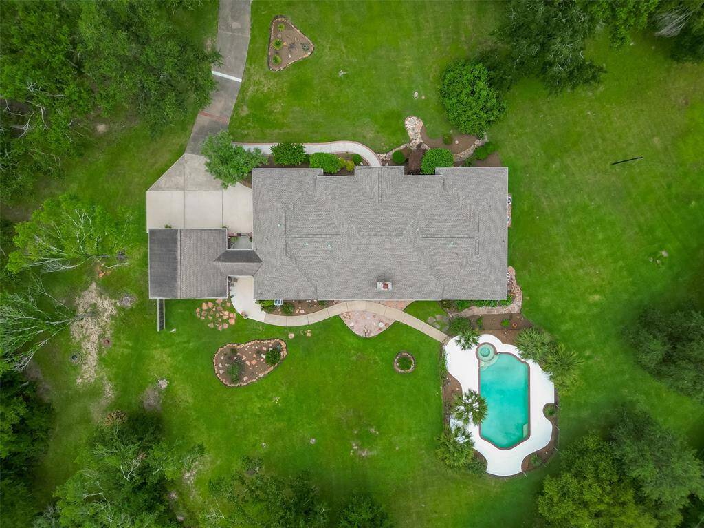 Enjoy peace, privacy, and room to roam on this expansive 2.45-acre property, beautifully dotted with mature trees, a private pool and even a small pond. Whether you're looking to relax under the shade, explore the landscape, or create your own outdoor haven, this picturesque yard offers endless possibilities.