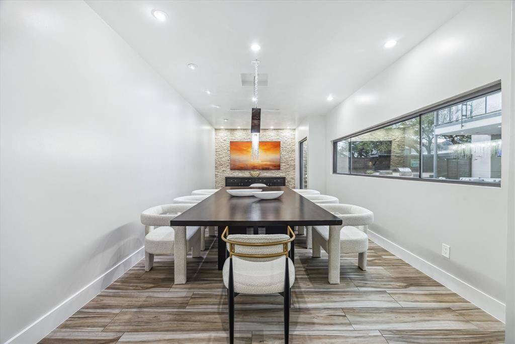 Here you'll enter the grand dining room. The space is well-lit with recessed lighting, and a large window provides natural light. Perfect for gatherings!