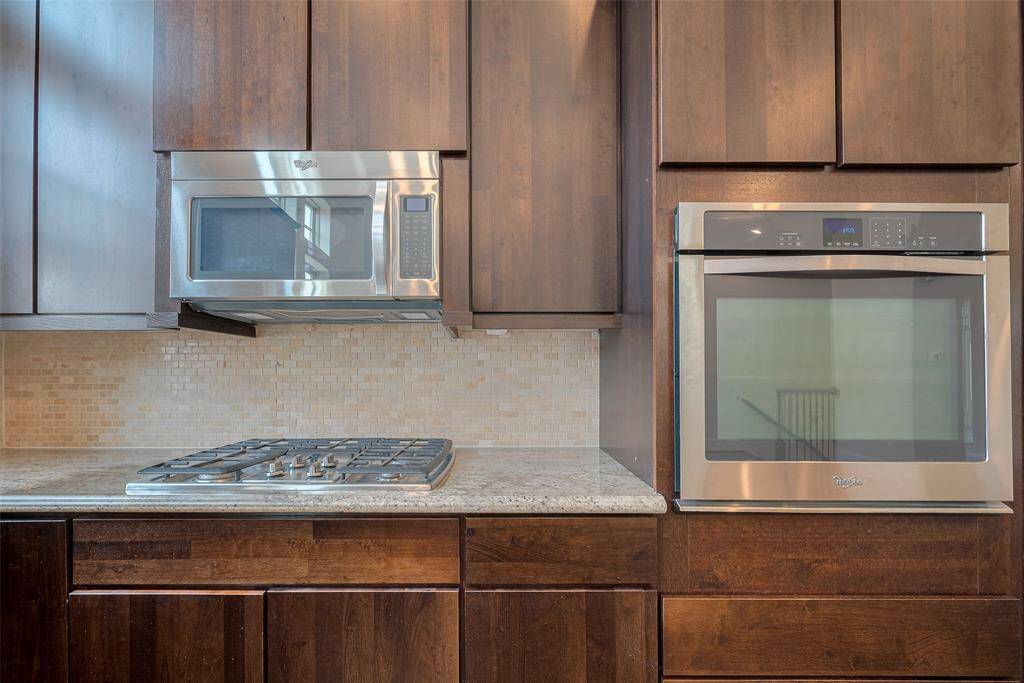 Stainless steel cooktop, microwave, and over.