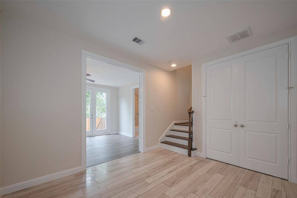Huge entry space - first floor bedroom to the left, storage closet next to stairs, and garage to the right.