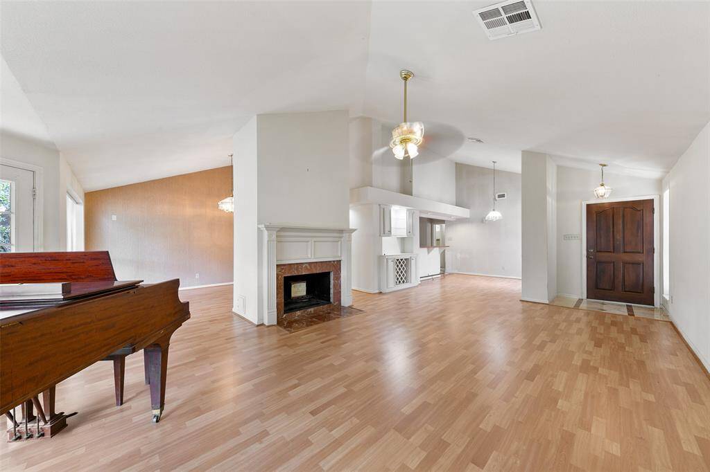 Expansive living room featuring soaring ceilings and a stylish fireplace—perfect for relaxing or entertaining.