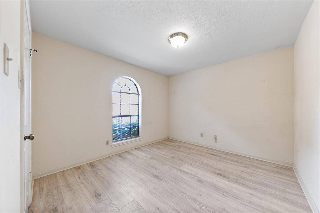Bedroom features low-maintenance laminate flooring and a simple, functional layout.