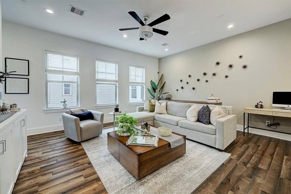 View of the  living/family room. It 's also nicely sized, and even though it's open to the kitchen, it feels like a separate room. The three windows bring in a lot of nice natural light