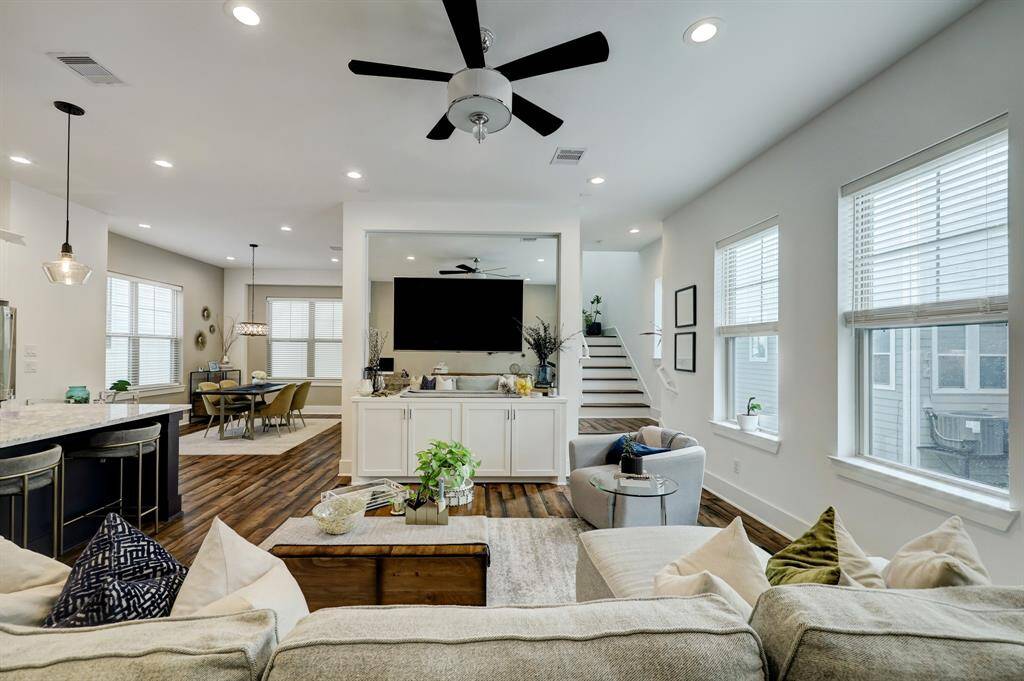 In this view from behind the couch, you can appreciate the mirror behind the TV that helps the space feels so chic
