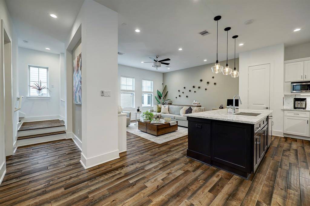 Interior wall with built ins creates some separation of spaces - and a place for art and a TV - while still retaining the benefits of an open floorplan. It also provides some privacy for guests using the the powder bath.