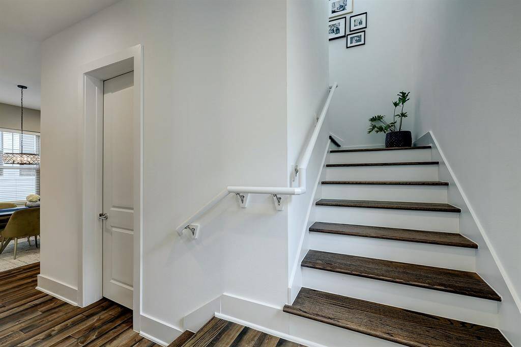 The staircase provides great wall space for art and photography. While pretty, it doesn't dominate the space, leaving additional options for furniture placement.