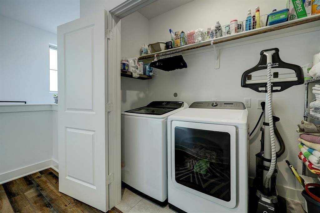 Laundry closet has good storage for cleaning supplies plus hanging space. The washer and dryer are included in the sale.