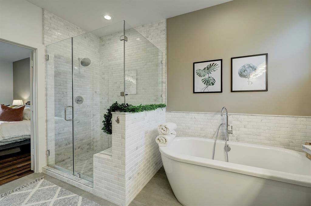 Separate walk-in shower and soaking tub are two of the features of the spa-like primary bathroom