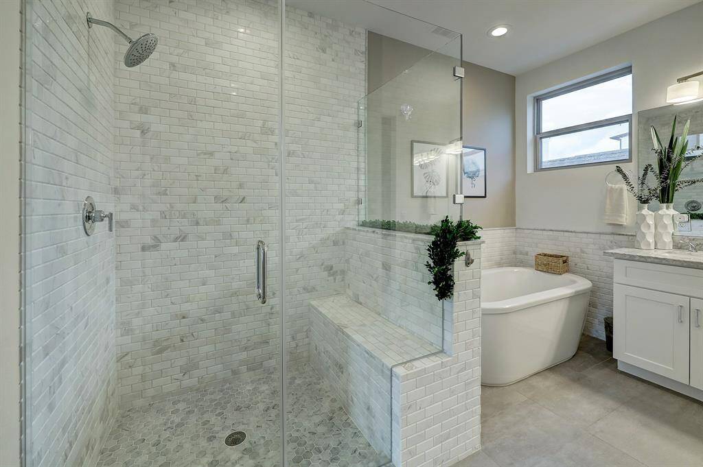 The large walk-in shower offers a built-in bench.