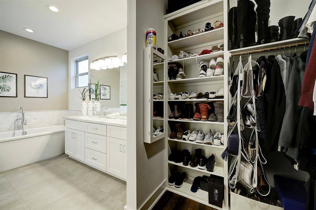 Another view of the primary closet with great  hanging and shelving.