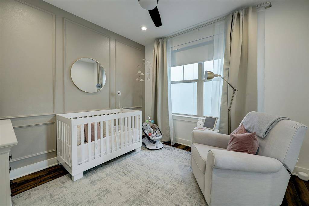 This secondary bedroom is around 11x11 and has great natural light plus an accent wall with moldings.