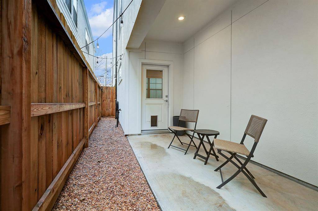 Ideal for pets to roam, the low maintenance yard is serviced by a doggy door.