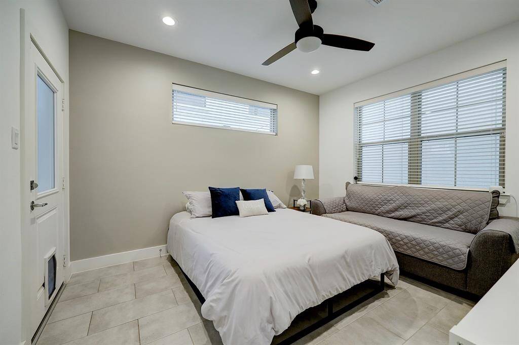 View of the first floor bedroom from the door. It has an access to the patio with a doggy door which makes it super convenient if you have a pet!