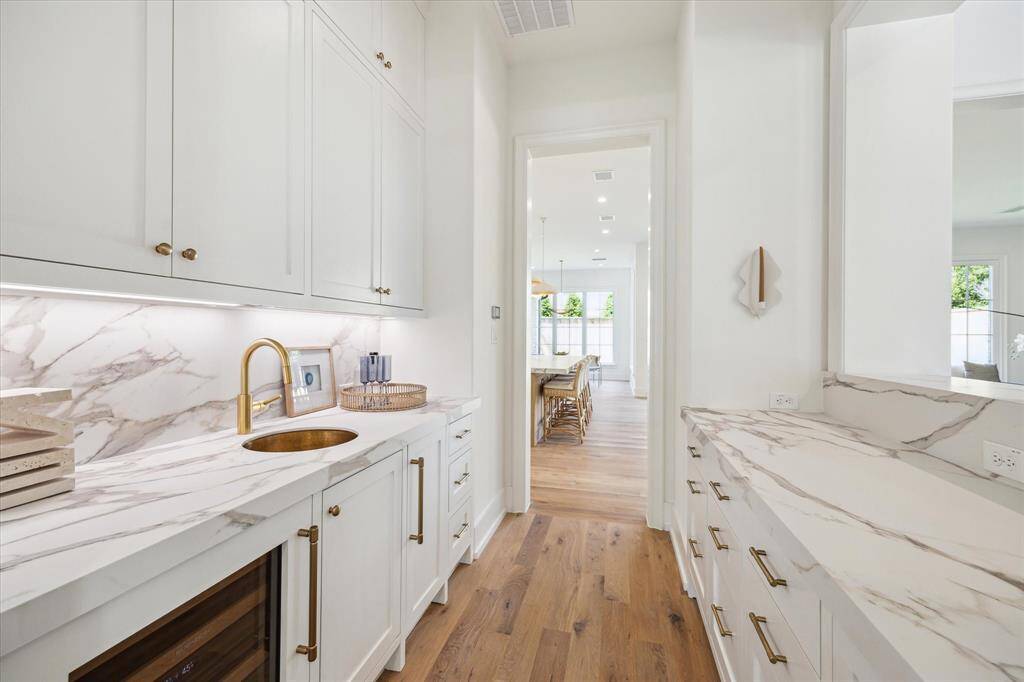 Wet bar connects the dining room and the kitchen, complete with a beverage fridge, sink and ice maker.
