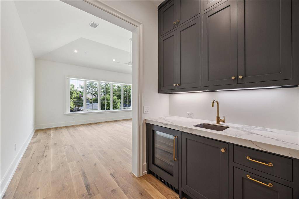 Tucked behind the kitchen you will find an added office/desk space with built-ins. This door leads to the 2-car garage.